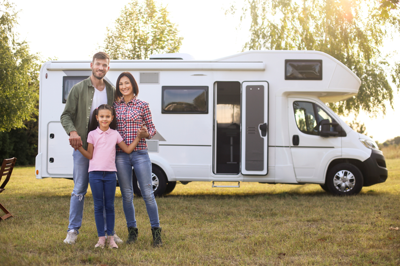 Family standing together in front of RV.
