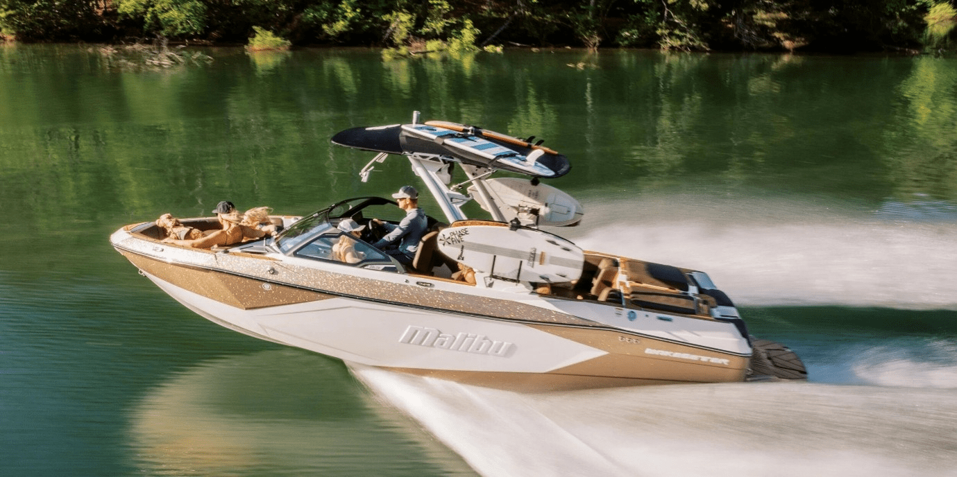 A person waterskiing behind a speedboat on calm water.